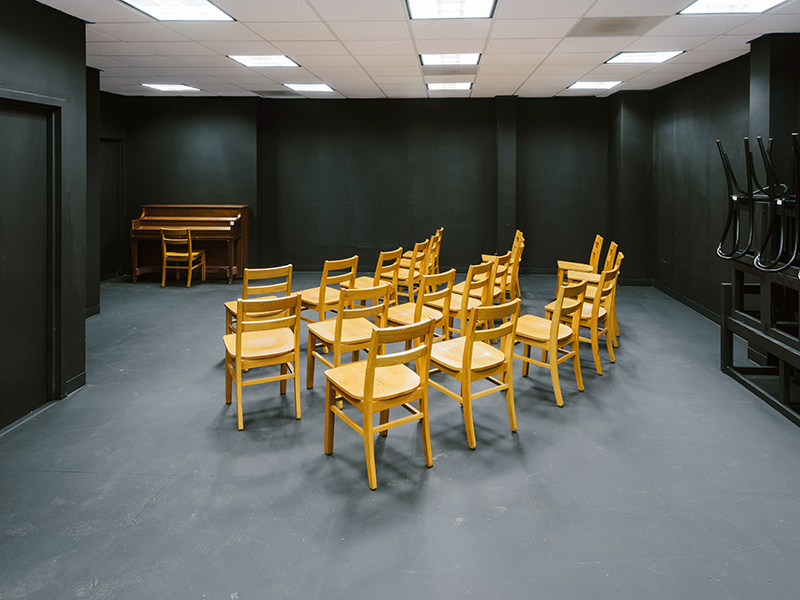 A black box acting classroom with chairs